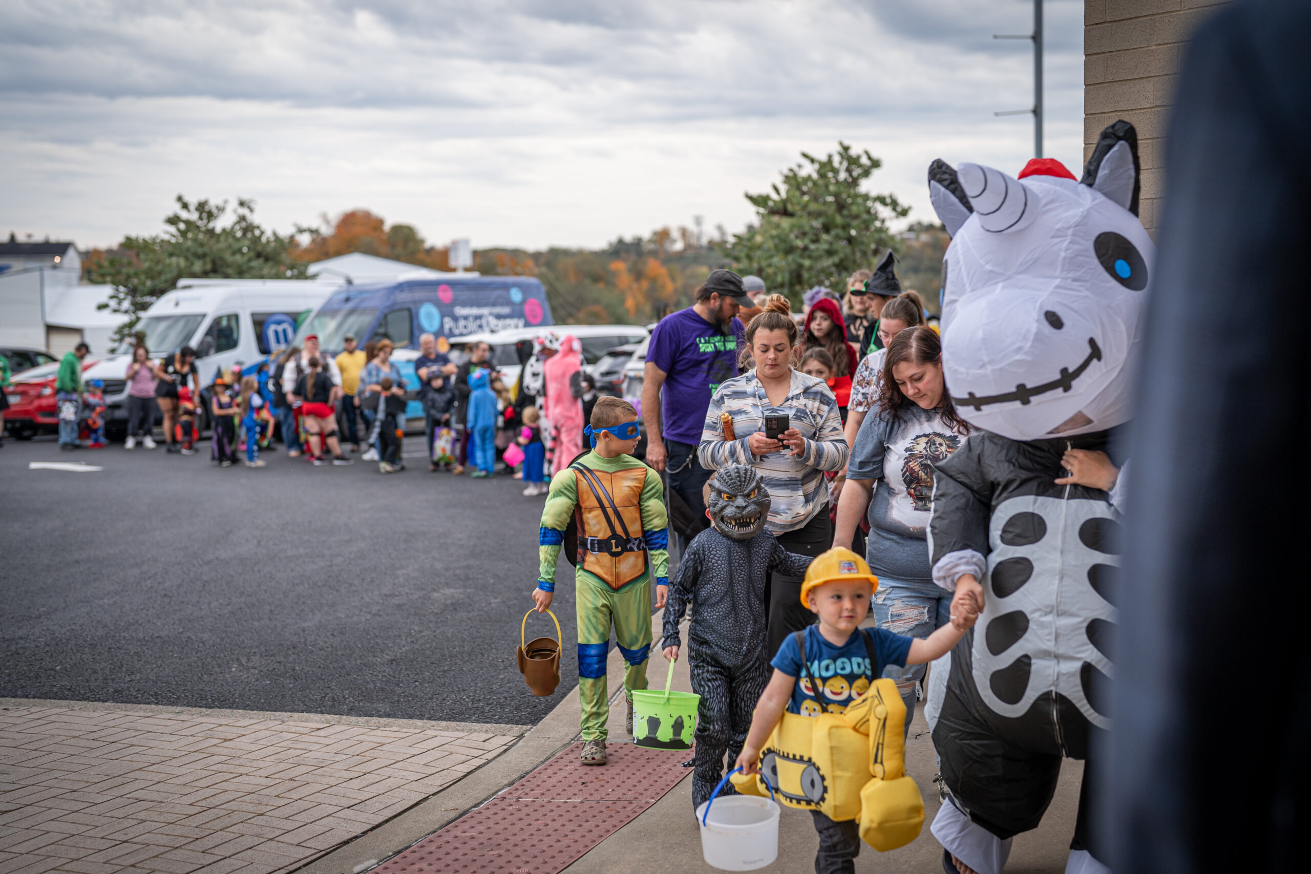 The image features a line of individuals dressed in costumes.