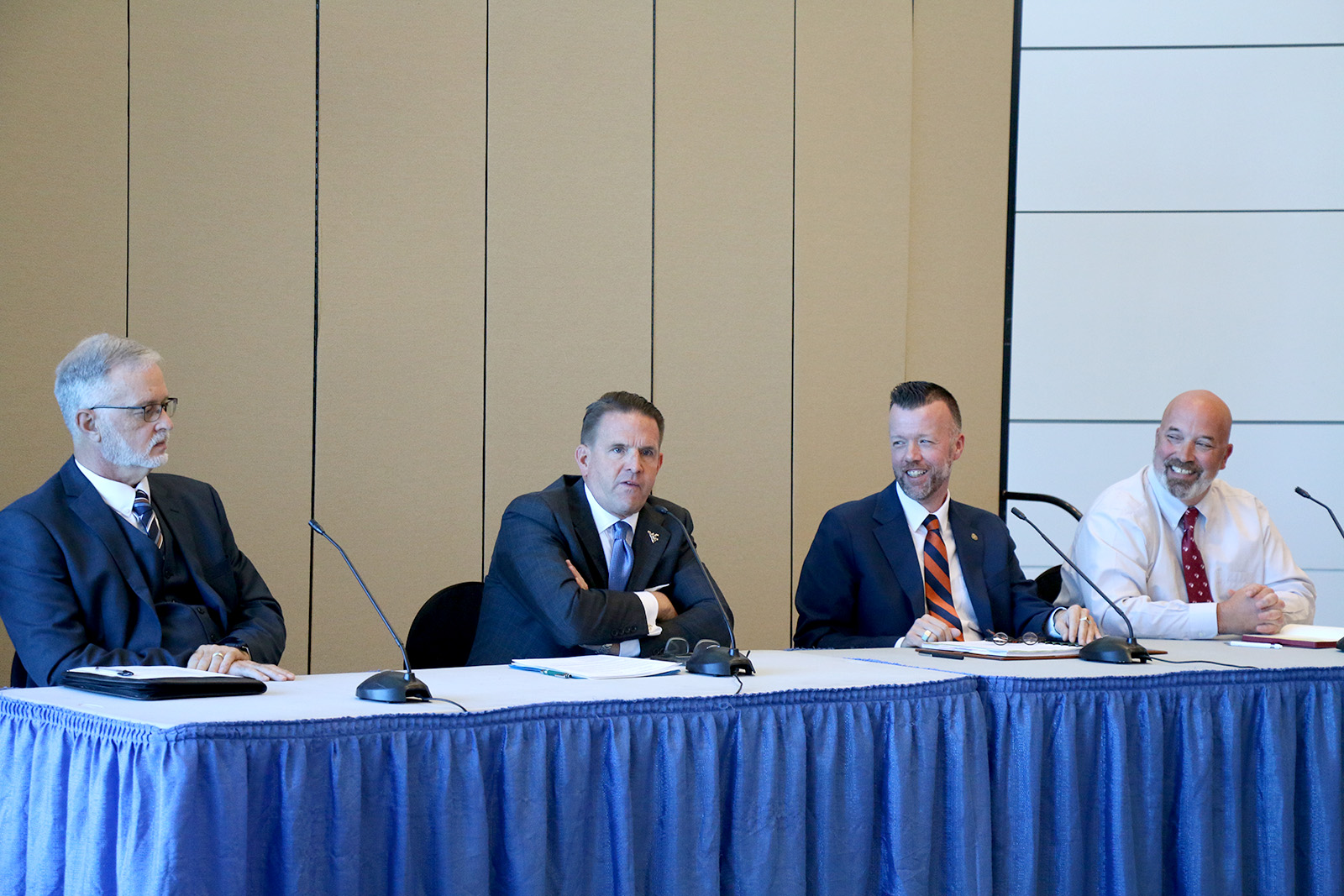 Four higher education leaders sit on stage during a panel discussion at the NCWV Business Summit. From left: Dr. Greg Kuhns, Michael Benson, Dr. Michael Waide, and Dr. Michael Davis
