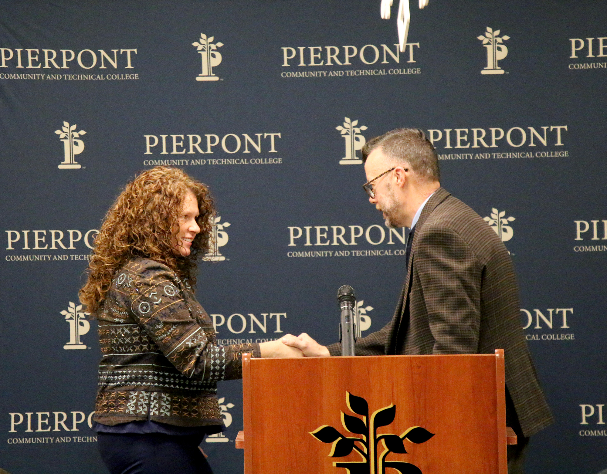 Dr. Torie Jackson, president of WVU Parkersburg, shakes hands with Dr. Michael Waide, interim president of Pierpont Community & Technical College, during a signing ceremony for two 2+2 articulation agreements at Pierpont’s Advanced Technology Center in Fairmont, W.Va., on Dec. 11, 2025.