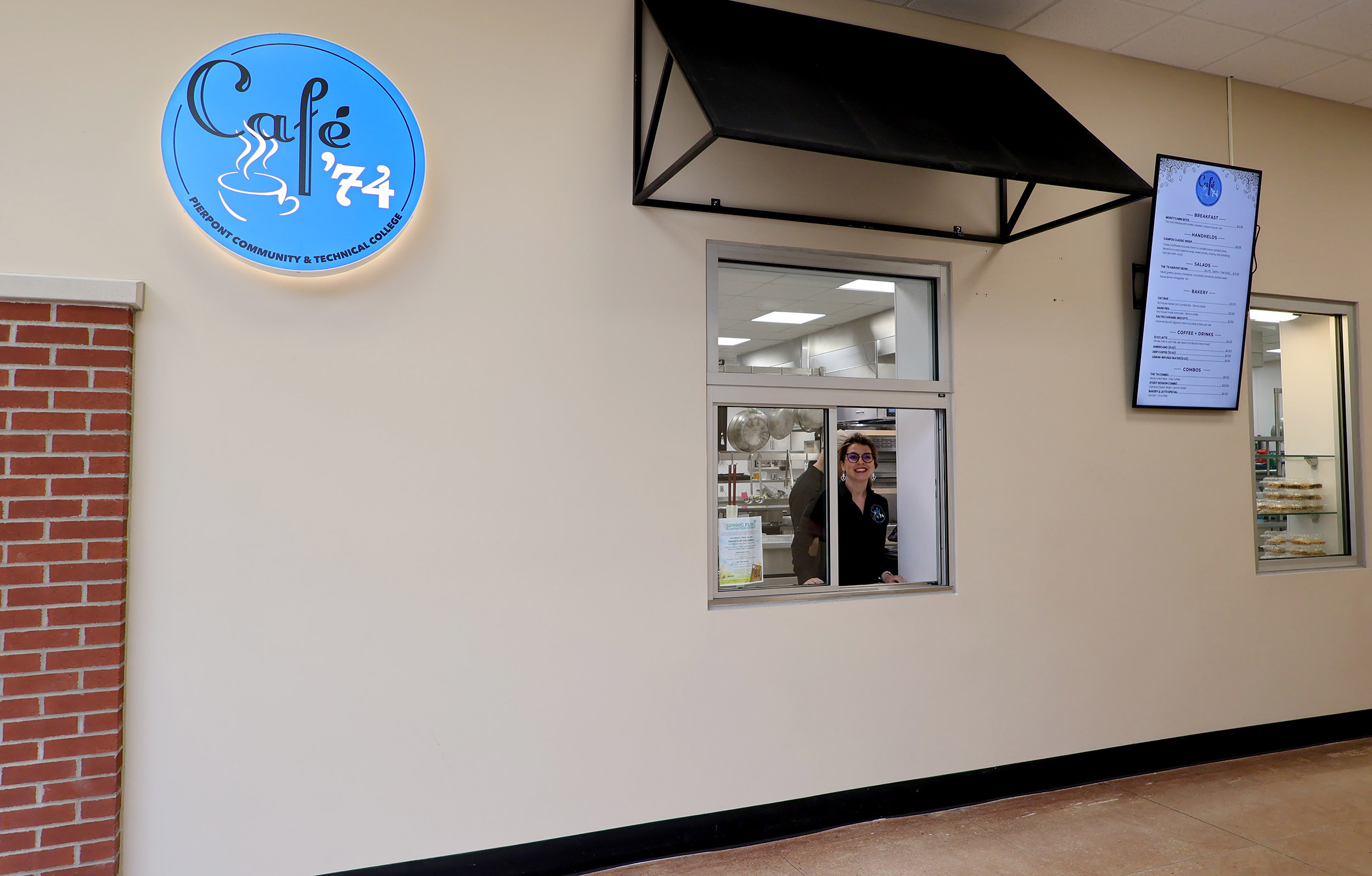 Natalie Feltz, program coordinator and associate professor for Pierpont’s Food Service Management program, works at the Café ’74 service window during the café’s soft opening at Middletown Commons.