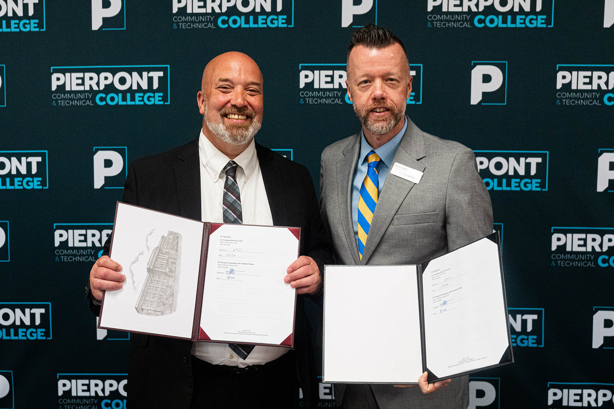 Dr. Mike Davis (left), President of Fairmont State University, and Dr. Michael Waide, President of Pierpont Community & Technical College, hold a newly signed agreement that expands access to bachelor’s and master’s degree programs for eligible Pierpont employees at a reduced tuition rate. Leaders from both institutions described the partnership as an investment in employees and a foundation for future collaboration.