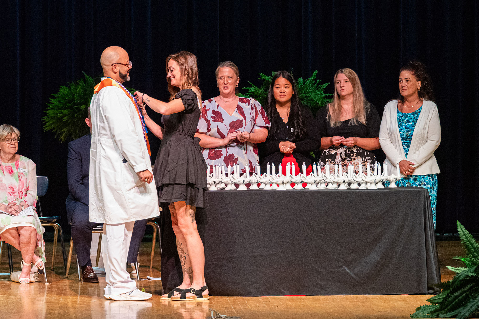 Elliott Allende, class president and student speaker for the Licensed Practical Nursing Class of 2026, receives a nursing pin during the LPN Pinning Ceremony.